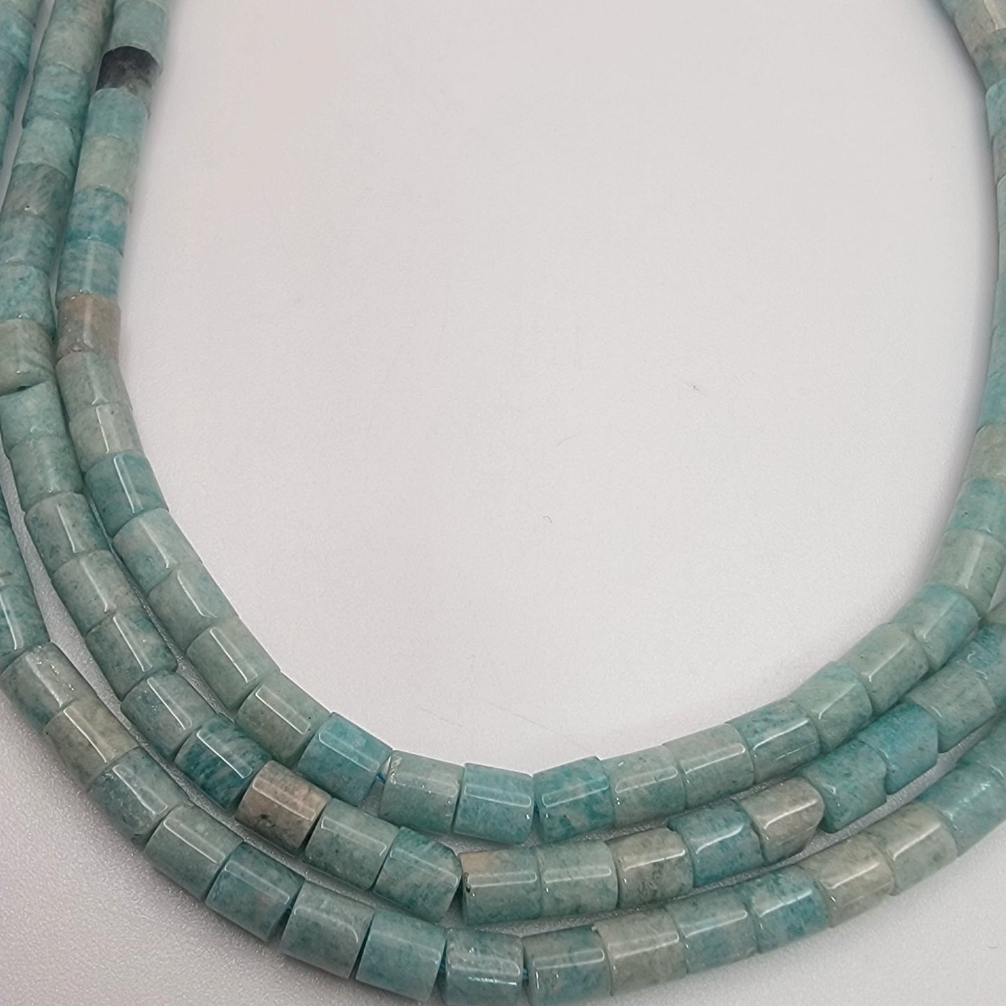 light green tube beads on white background