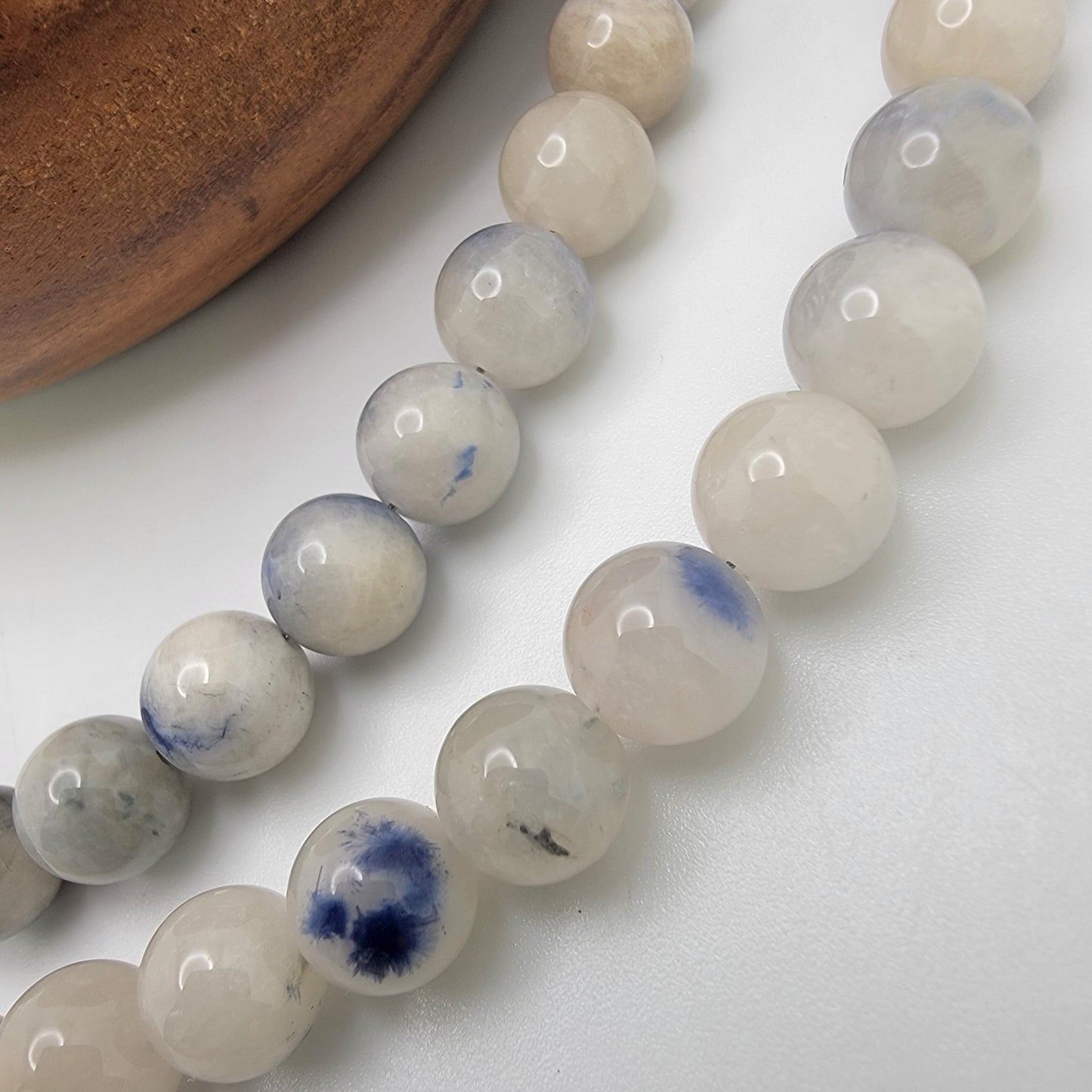 Close-up of blue and white beads on a white background