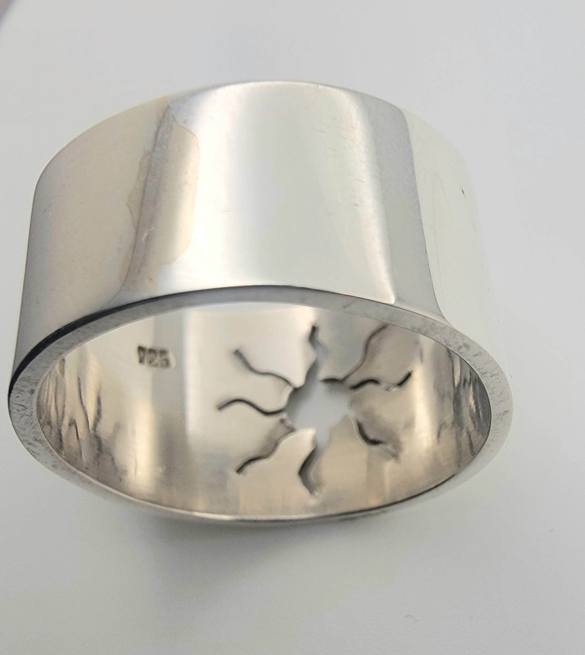 Detailed image of the 925 Sterling Silver Wideband Sunburst Ring, emphasizing its polished finish and sunburst cutout. This handcrafted ring represents modern silver ring craftsmanship, ideal for those who love bold silver bands and celestial jewelry.