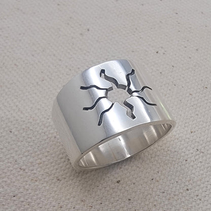 Close-up view of the 925 Sterling Silver Wideband Sunburst Ring showcasing its striking sun cutout design on a bold silver band. This artisan jewelry piece is perfect for casual wear, adding a modern touch to your summer jewelry collection with its unique silver ring style.