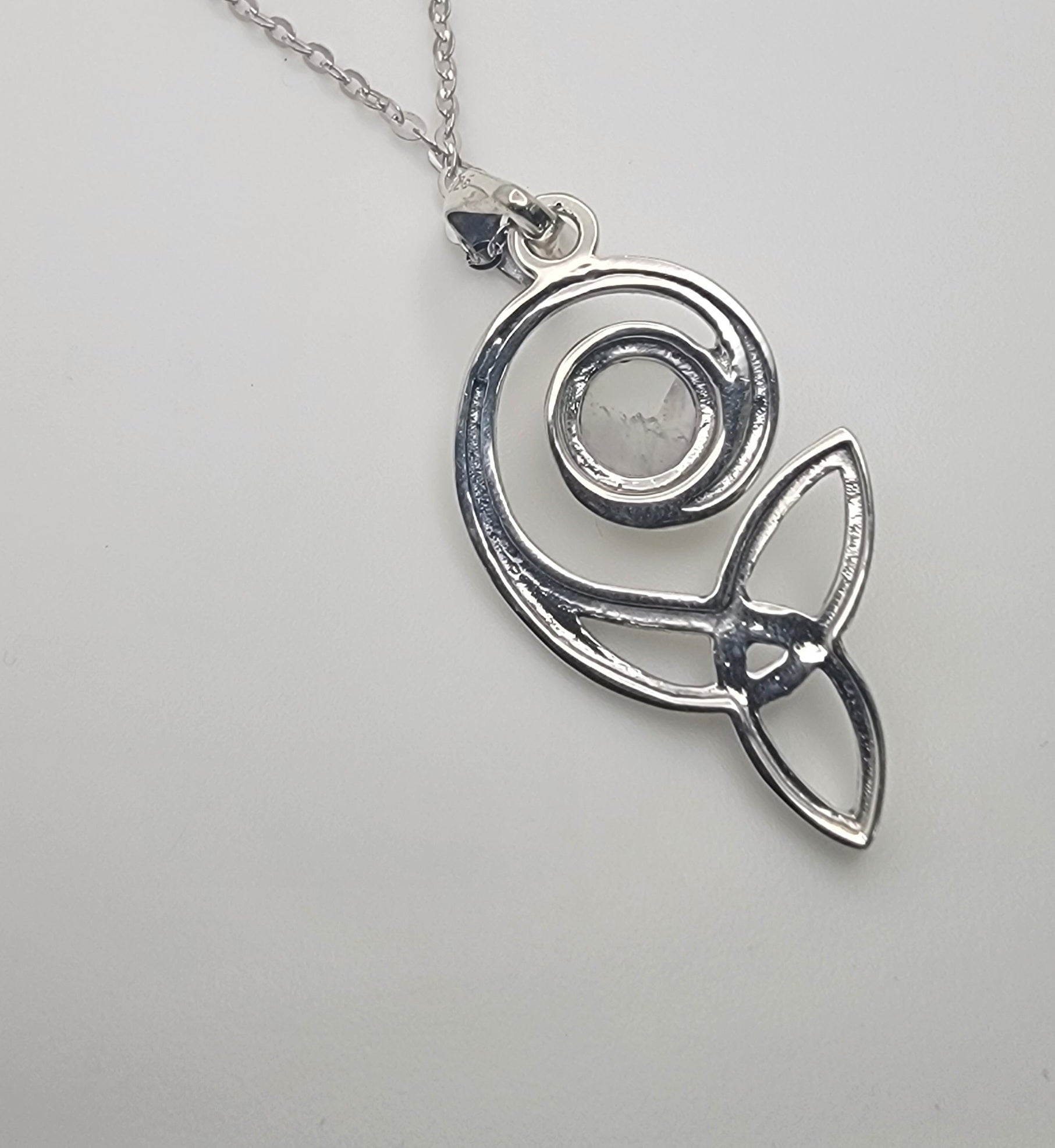 Close-up of the Celtic Swirl Sterling Silver Moonstone Necklace showcasing the intricate design and luminous cabochon moonstone.