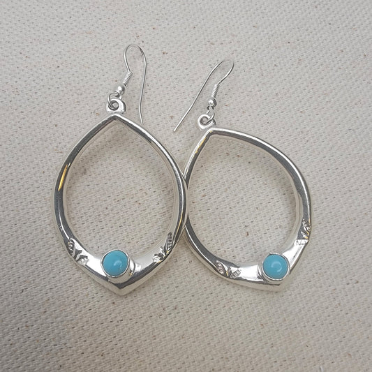 Teardrop Sterling Silver Earring with Turquoise Cabochon on neutral background