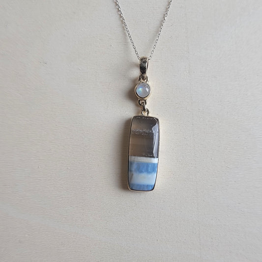 Blue Opal and moonstone necklace with a pendant on a light gray background