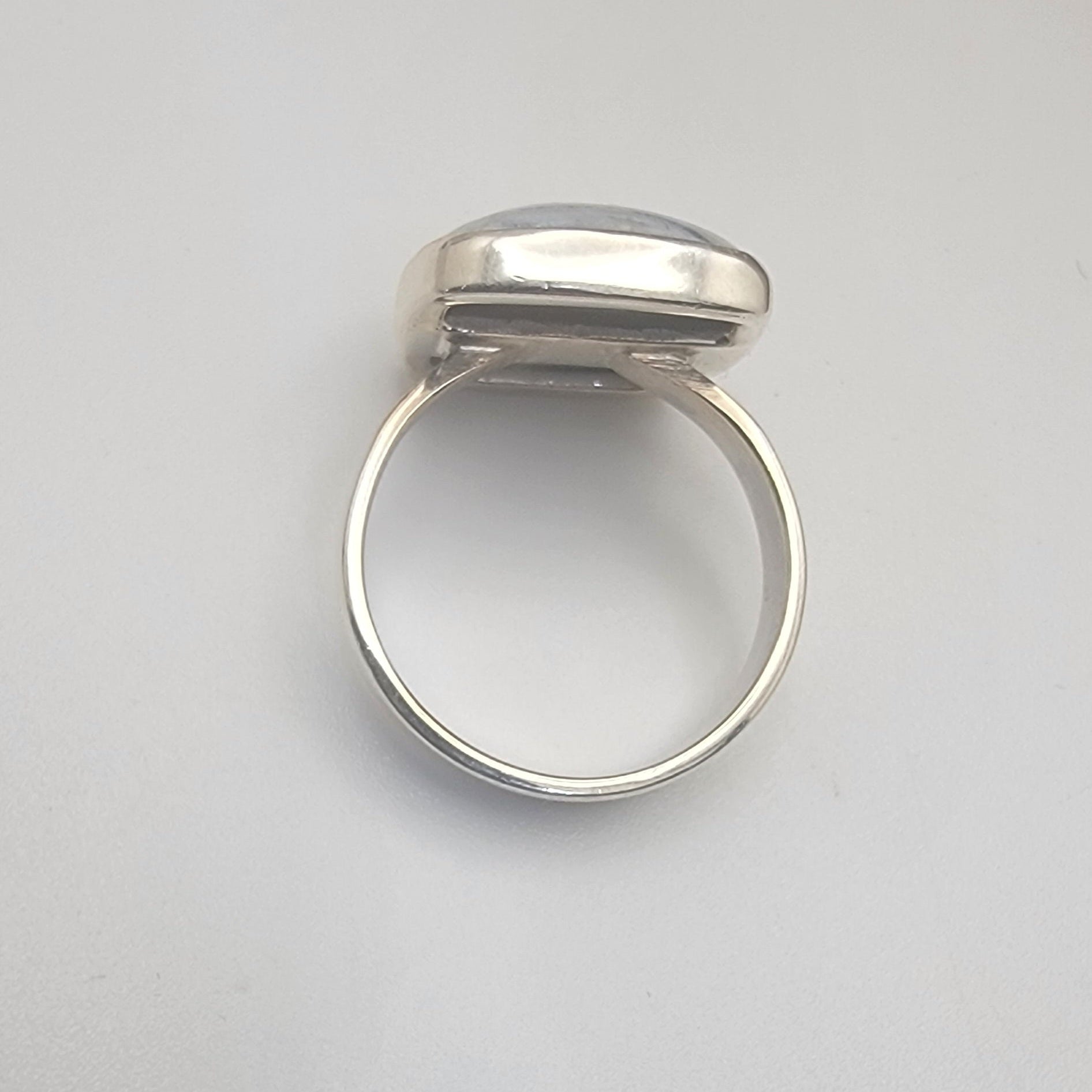 Silver ring on a light gray background