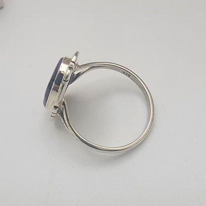 Silver ring on a light gray background