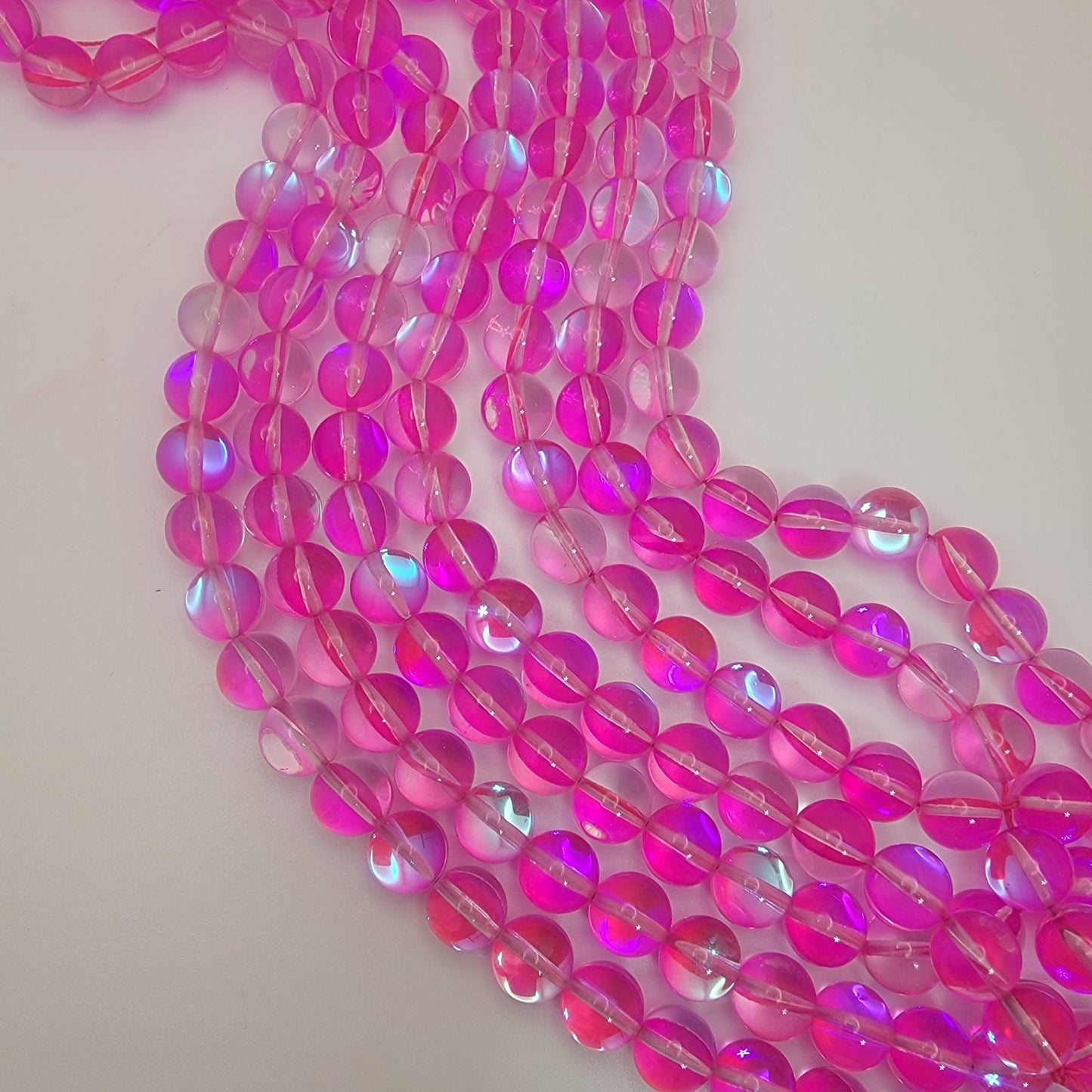 10mm round rose quartz beads on an neutral background