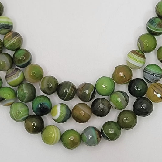 Green and brown marbled beads on a white background