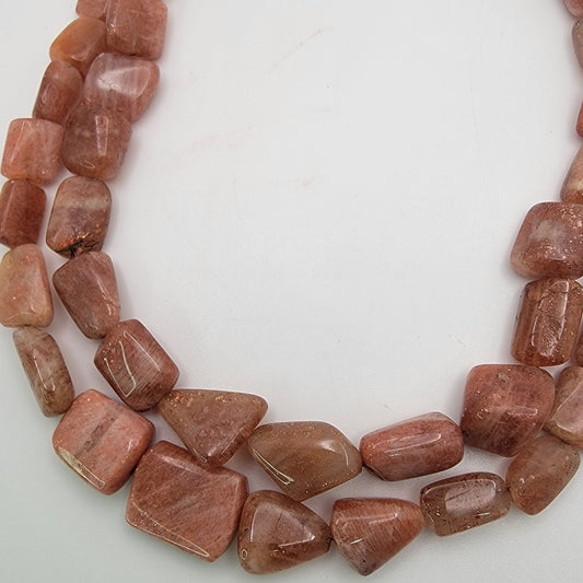 Brown stone beads on a white background