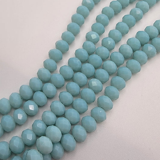String of light blue beads on a light gray background