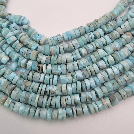 Larimar bead strands on a light gray background
