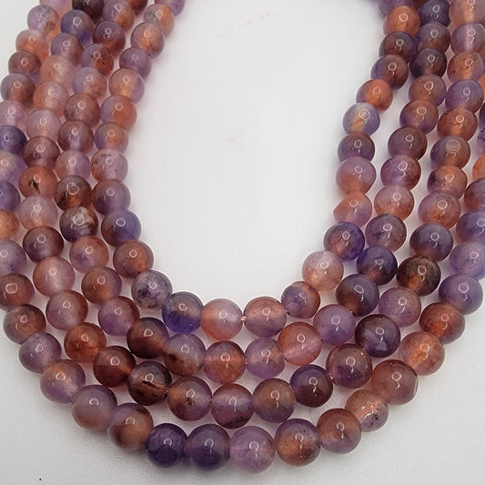 Purple and brown bead strands on white background