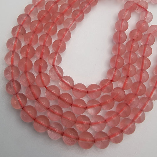 Strand of pink beads on a white background