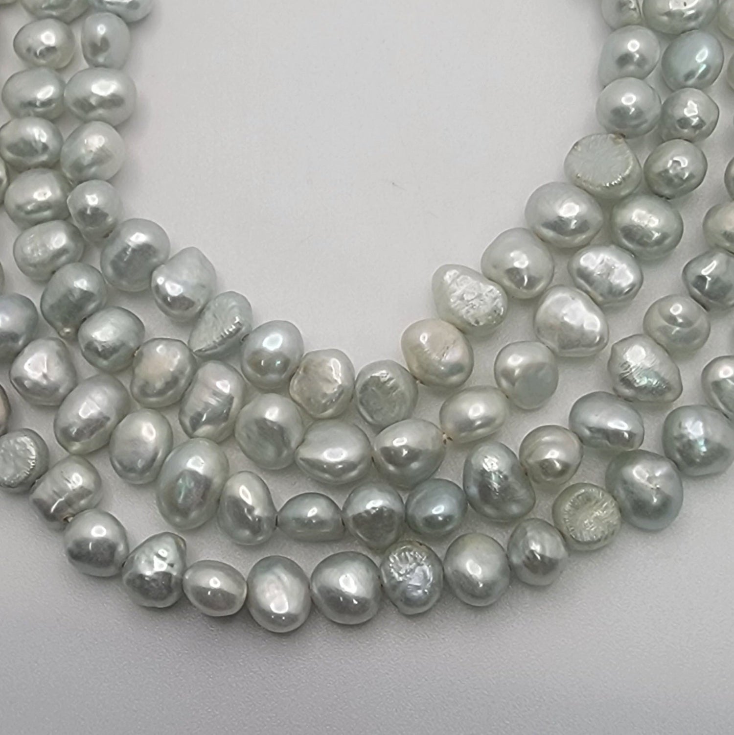 Light blue bead strands on white background