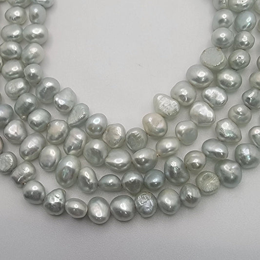 Light blue bead strands on white background