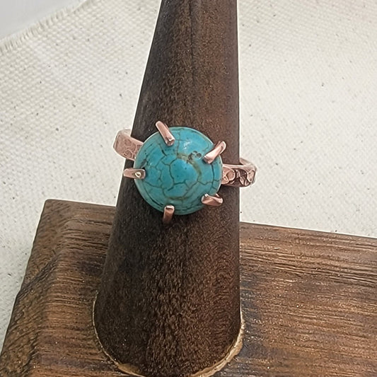 Turquoise Cabochon Copper Band Ring Displayed on Wood Ring Holder on Neutral Background