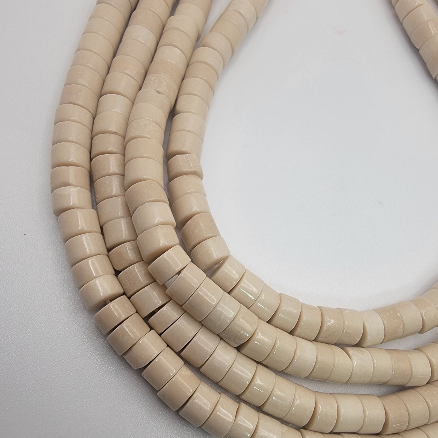 Beige beads on a white background