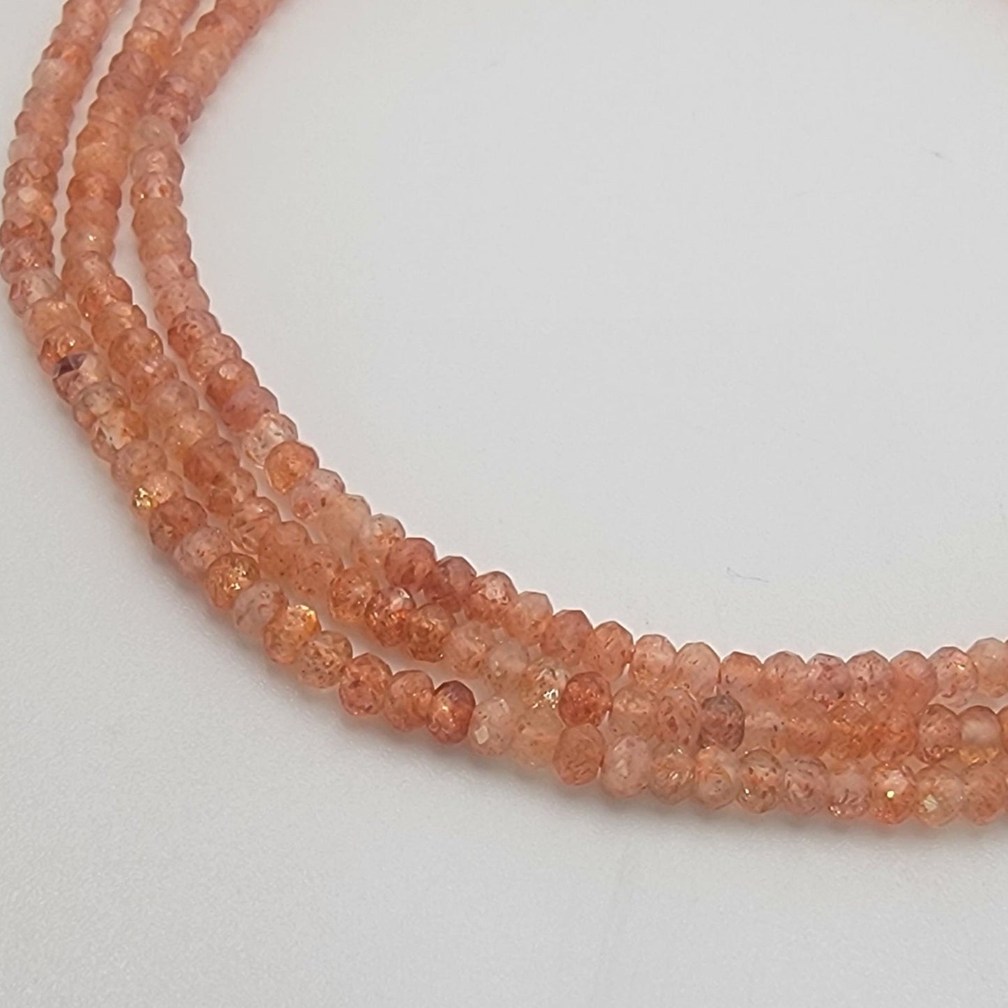 peach-colored beads on a light gray background