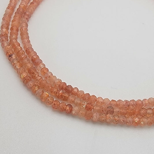 peach-colored beads on a light gray background