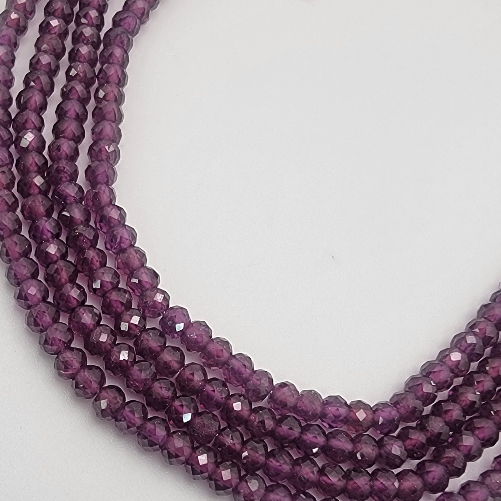 Purple beaded strands on a white background