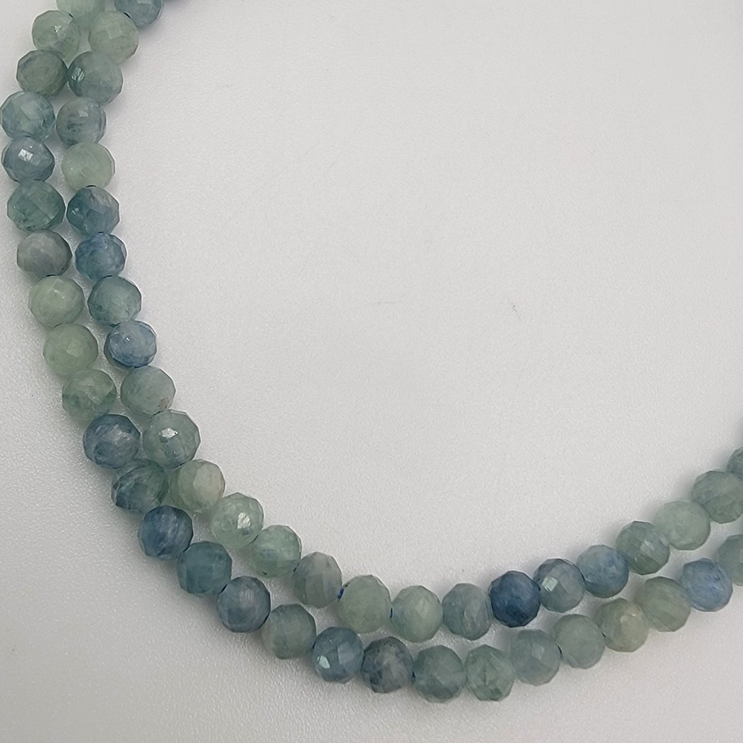 blue and green beaded stones on a white background