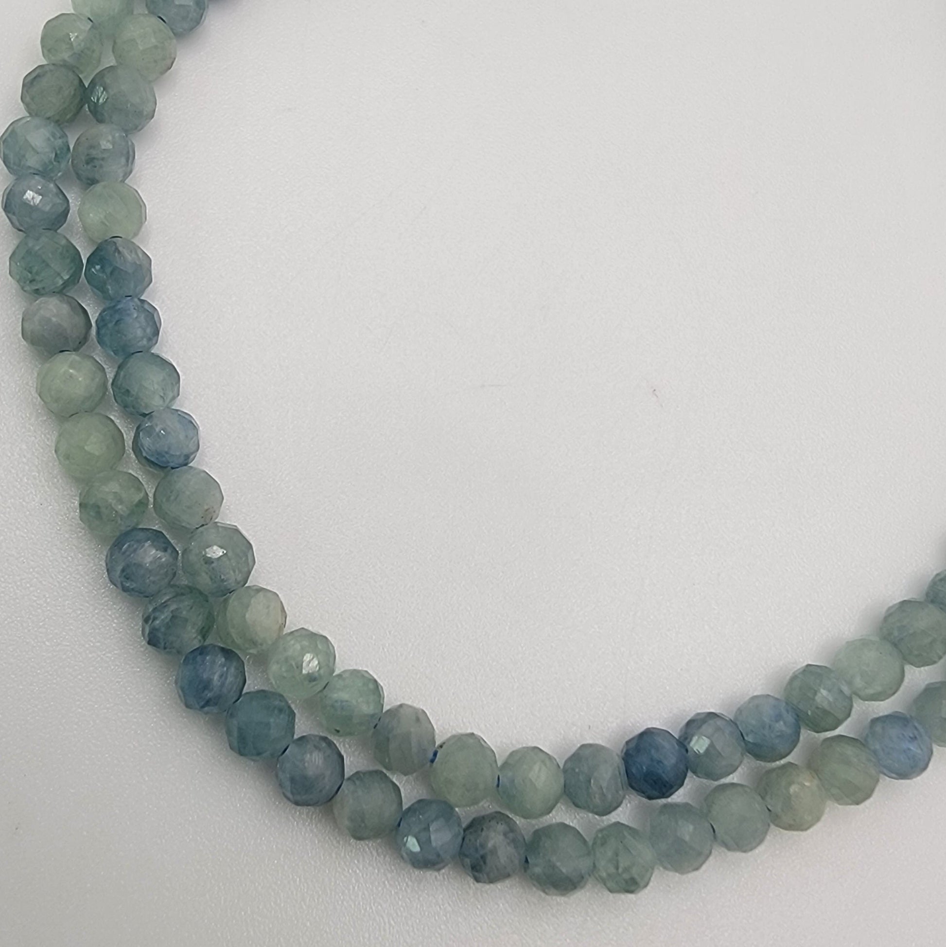 blue and green beaded stones on a white background