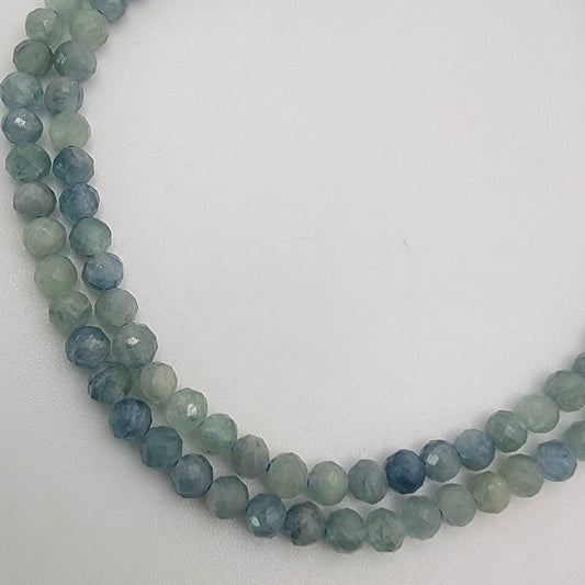 blue and green beaded stones on a white background