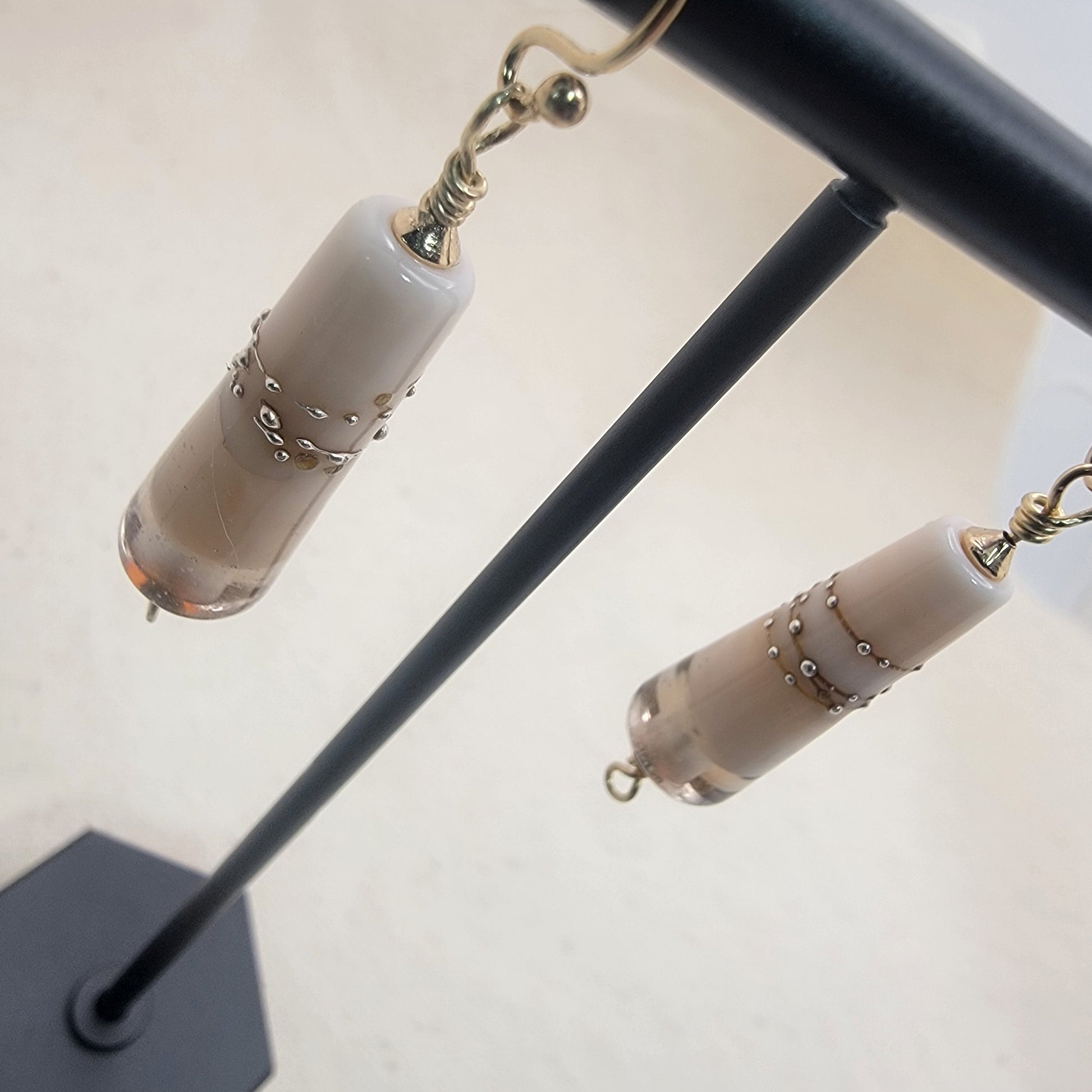 Cone shaped glass bead dangle earrings with gold filled ear wire on a neutral background