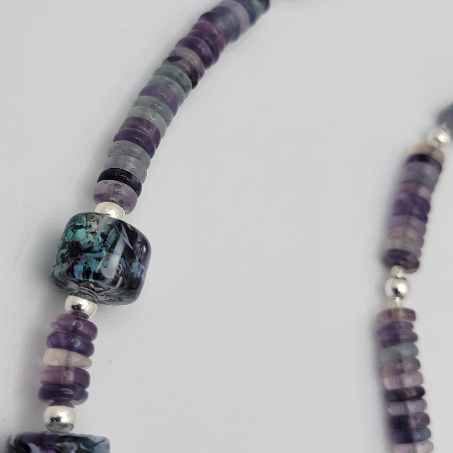 Necklace with multicolored beads on a white background