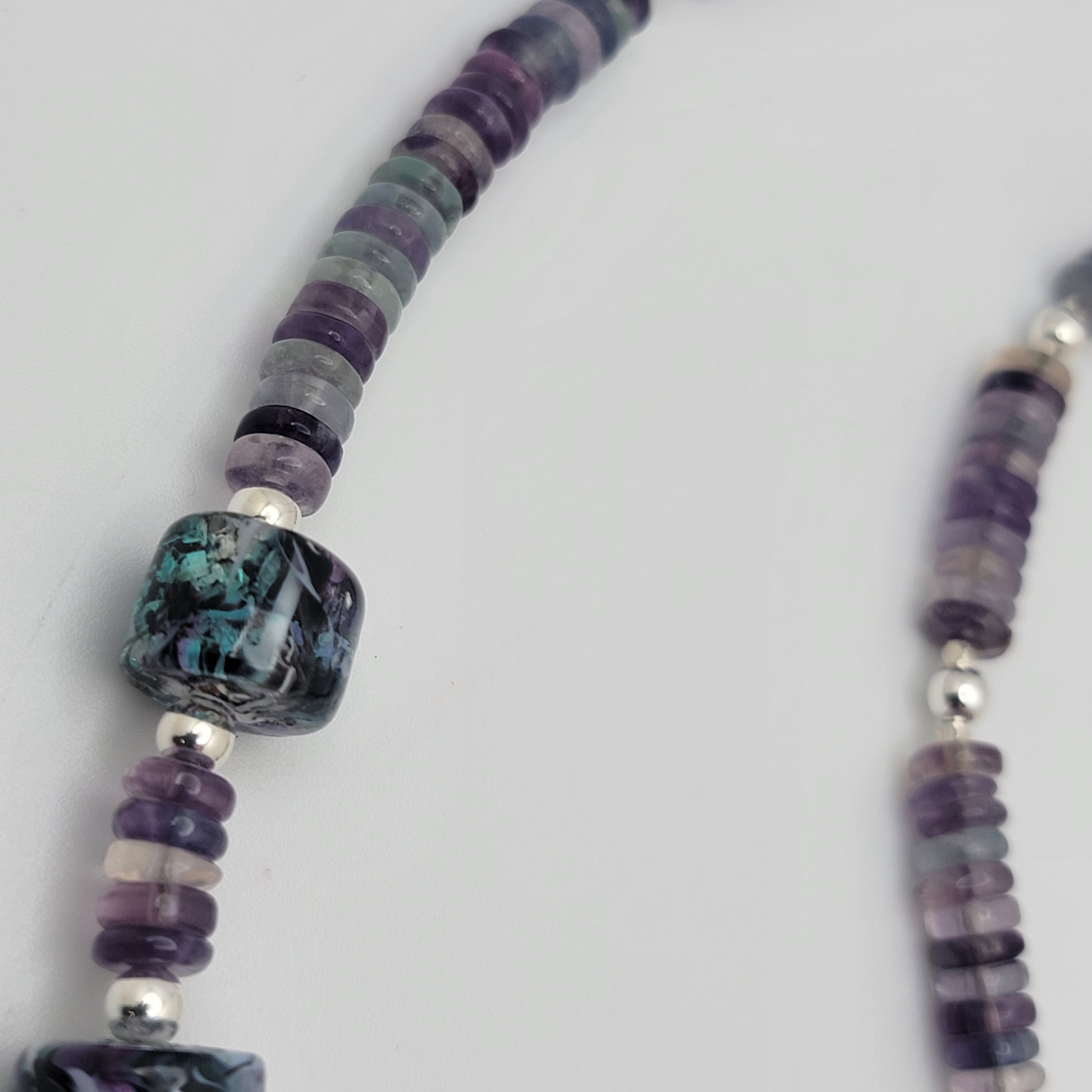 Necklace with multicolored beads on a white background
