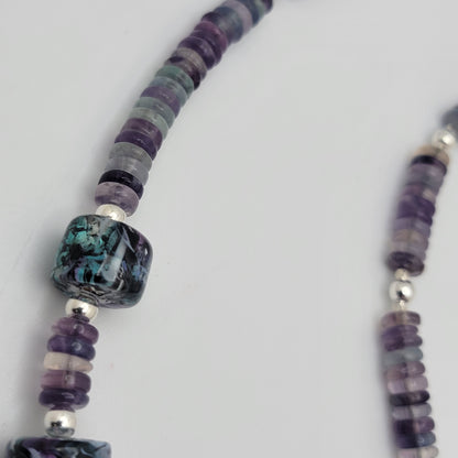 Necklace with multicolored beads on a white background