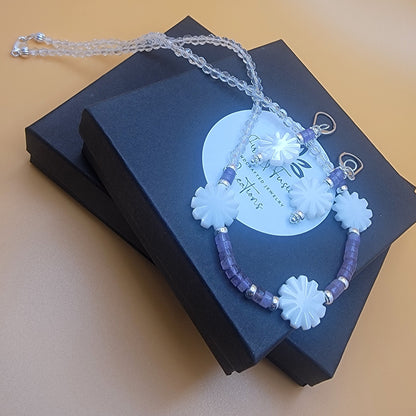 Bracelet with floral designs on a black box against a yellow background