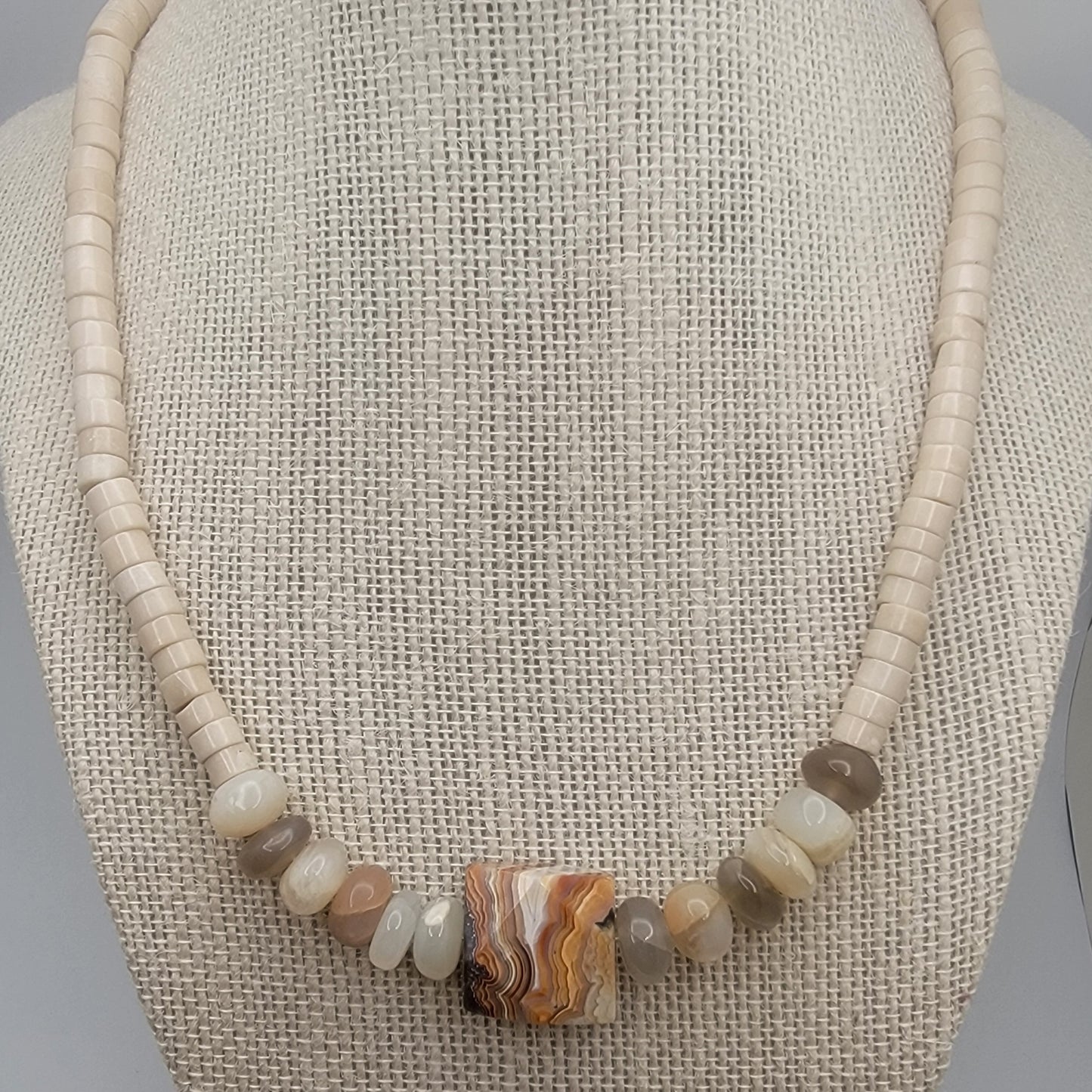 Necklace with natural stone beads on a textured surface