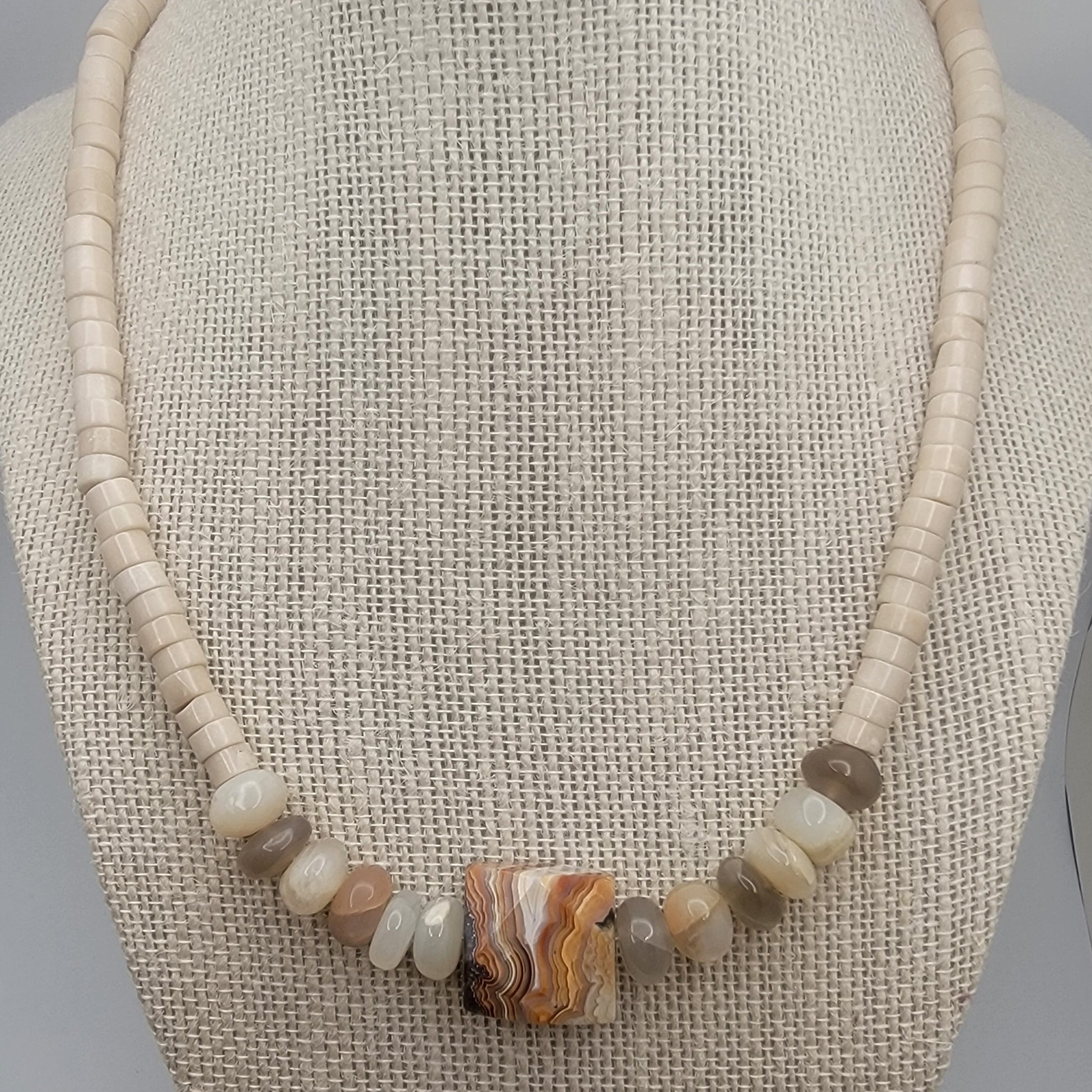 Necklace with natural stone beads on a textured surface