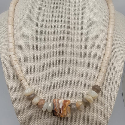 Necklace with natural stone beads on a textured surface