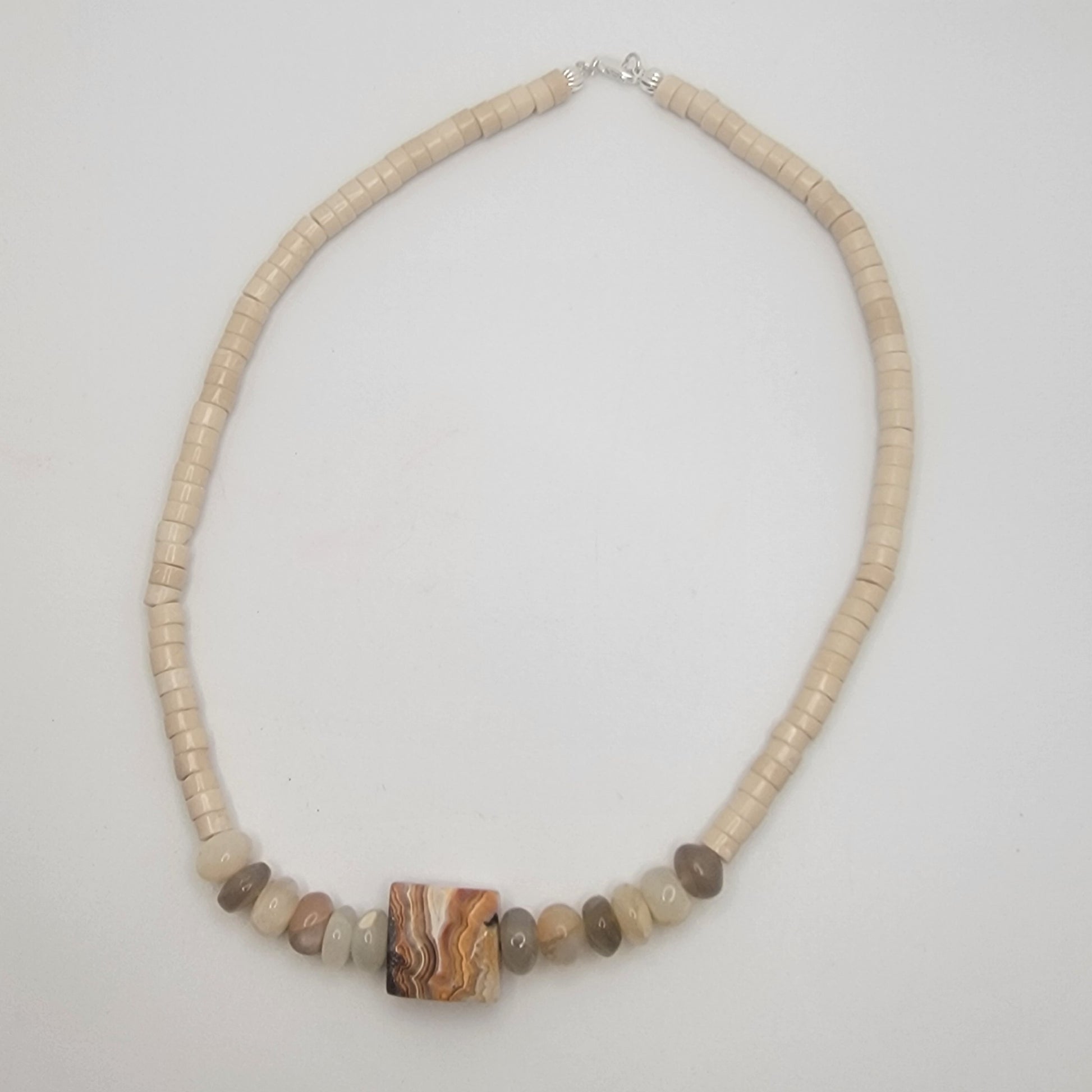 Necklace with natural stone beads on a light gray background