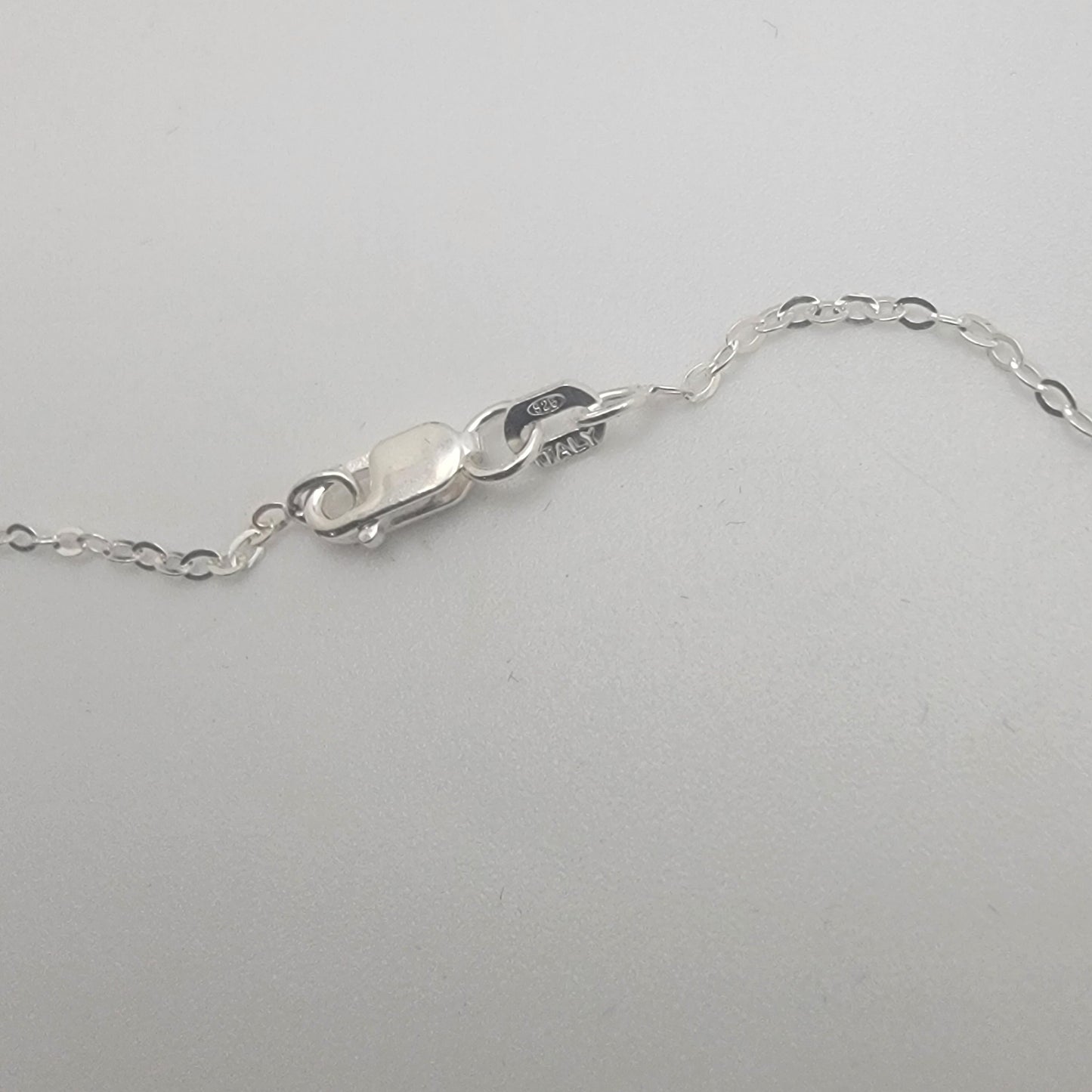 Close-up of a silver chain on a white background