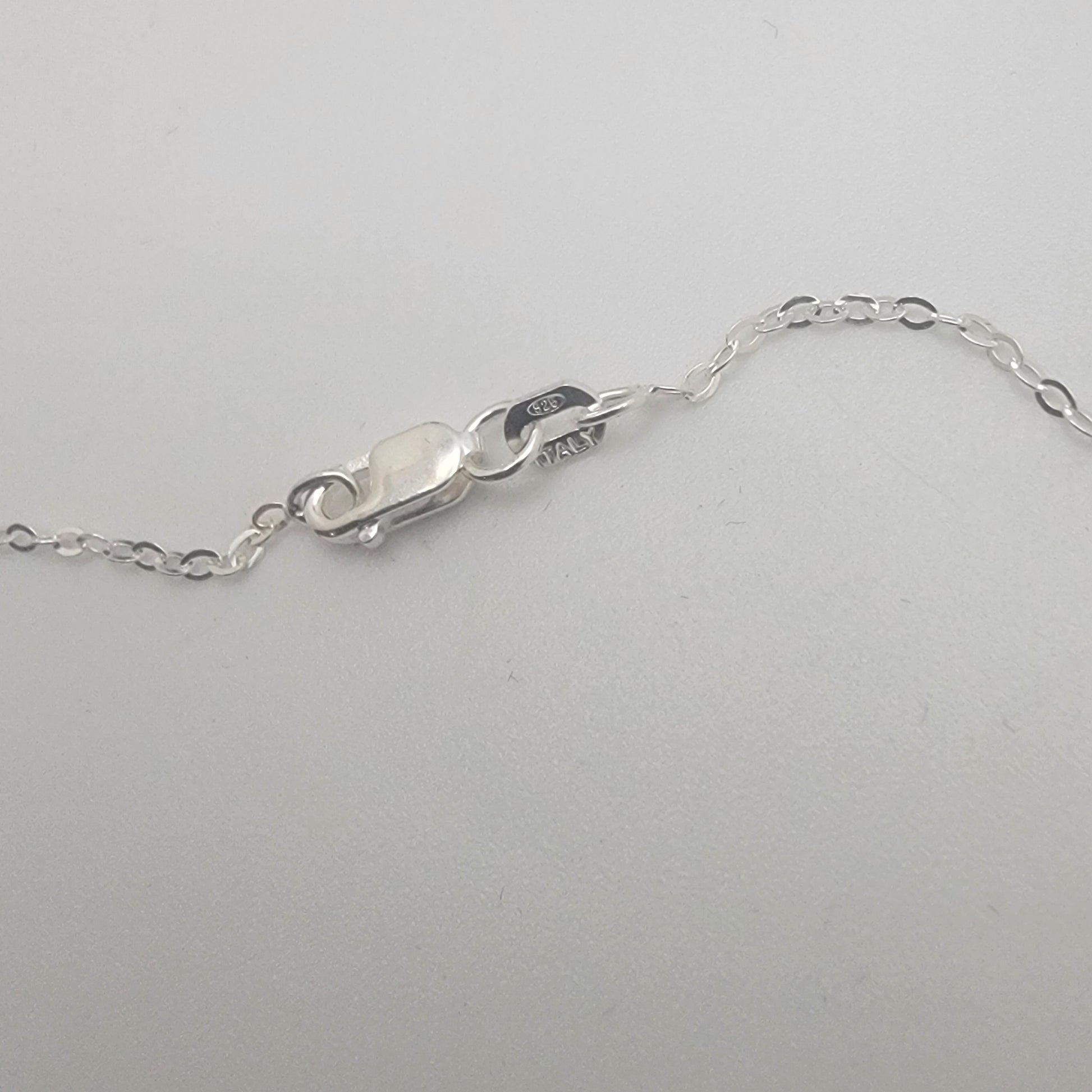 Close-up of a silver chain on a white background