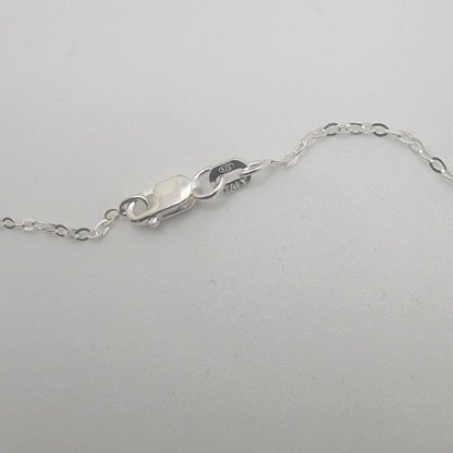 Close-up of a silver chain on a white background