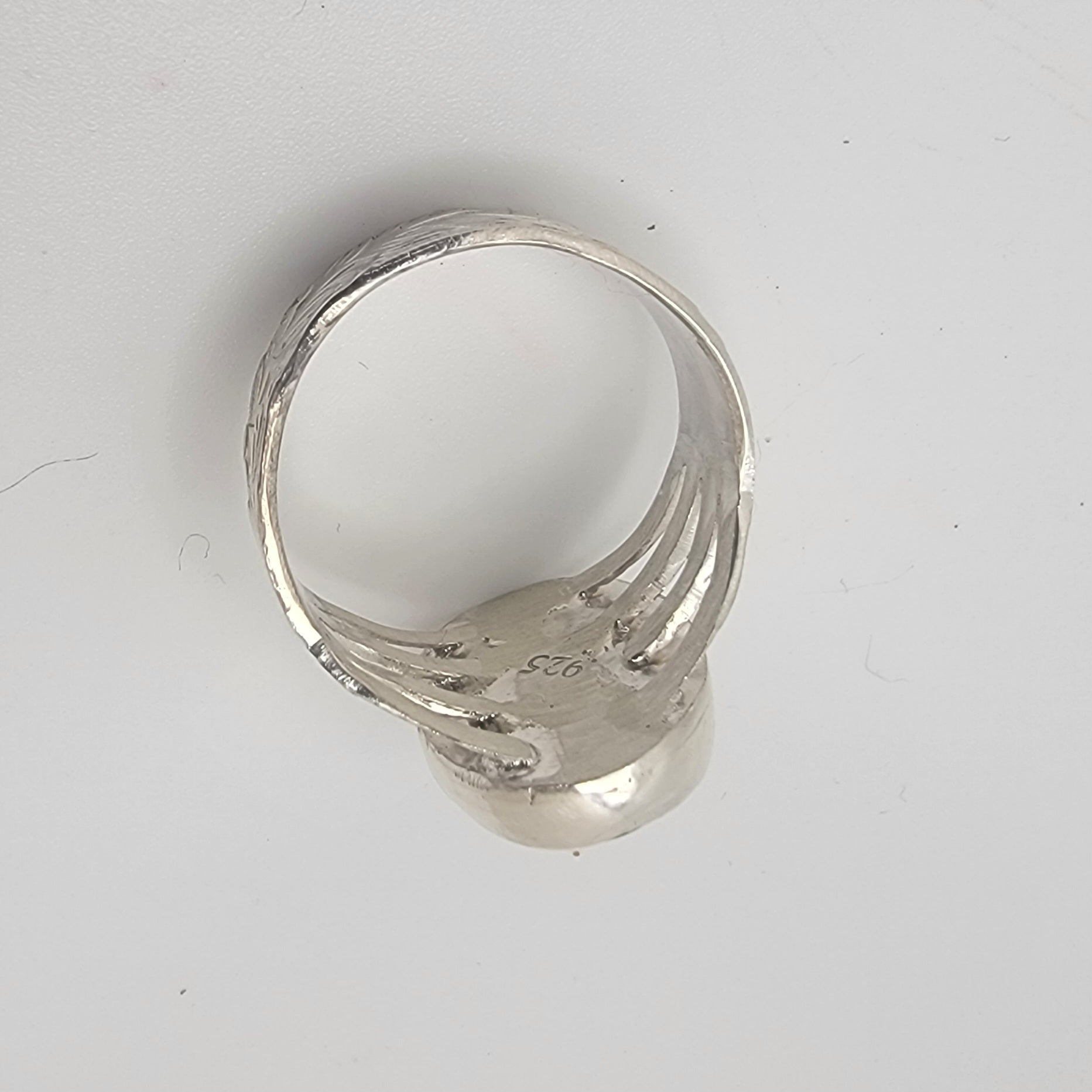 Silver ring on a white background