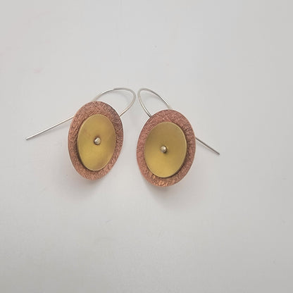 Pair of copper and brass disc earrings   on a white background