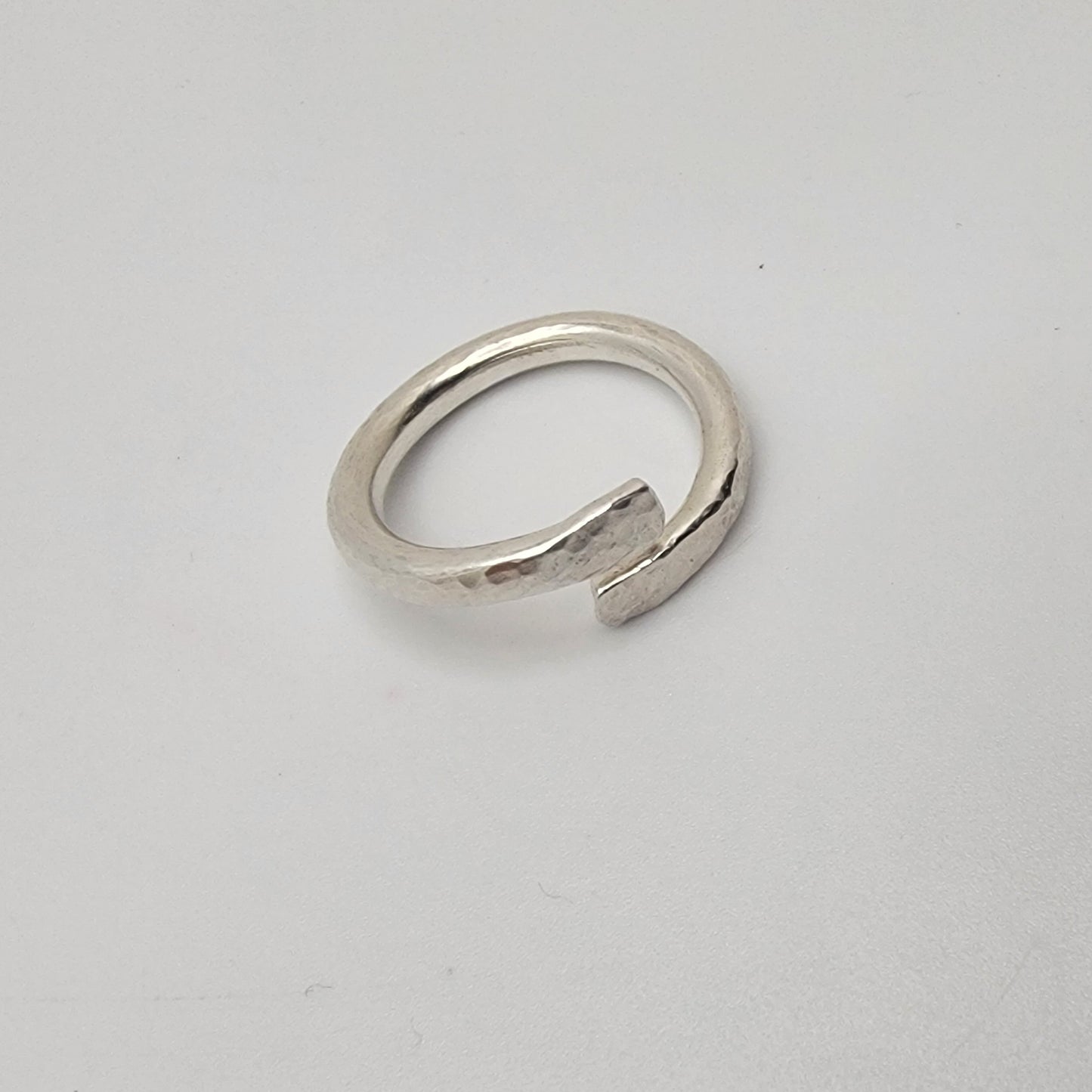 Silver ring on a light gray background