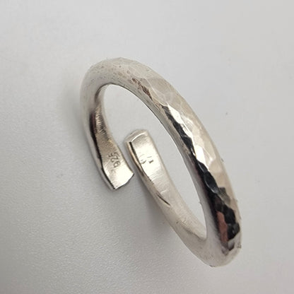 Silver rings with a textured finish on a light gray background