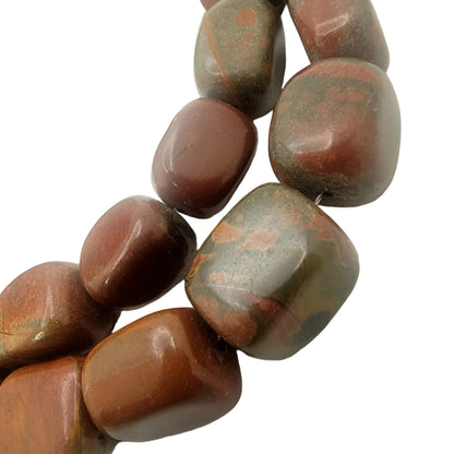 Close-up of brown stone beads on a white background
