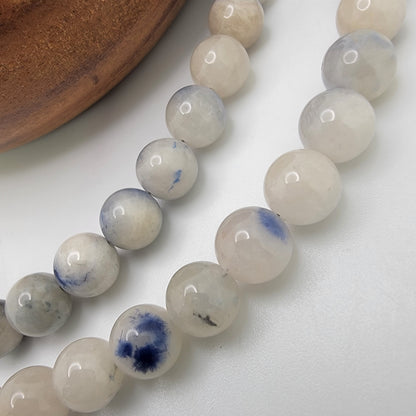 Close-up of blue and white beads on a white background