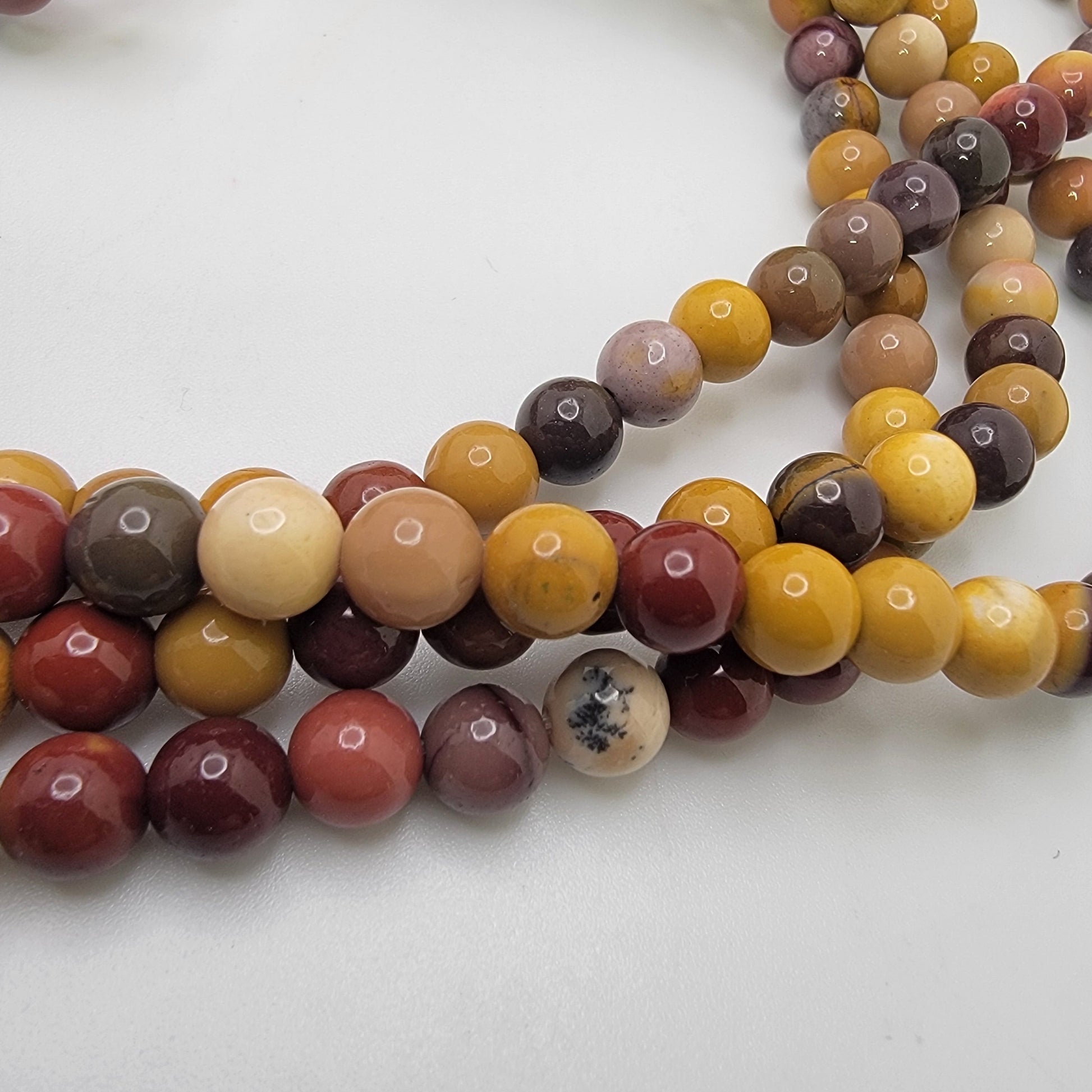 Colorful red, yellow and brown beads on a white background