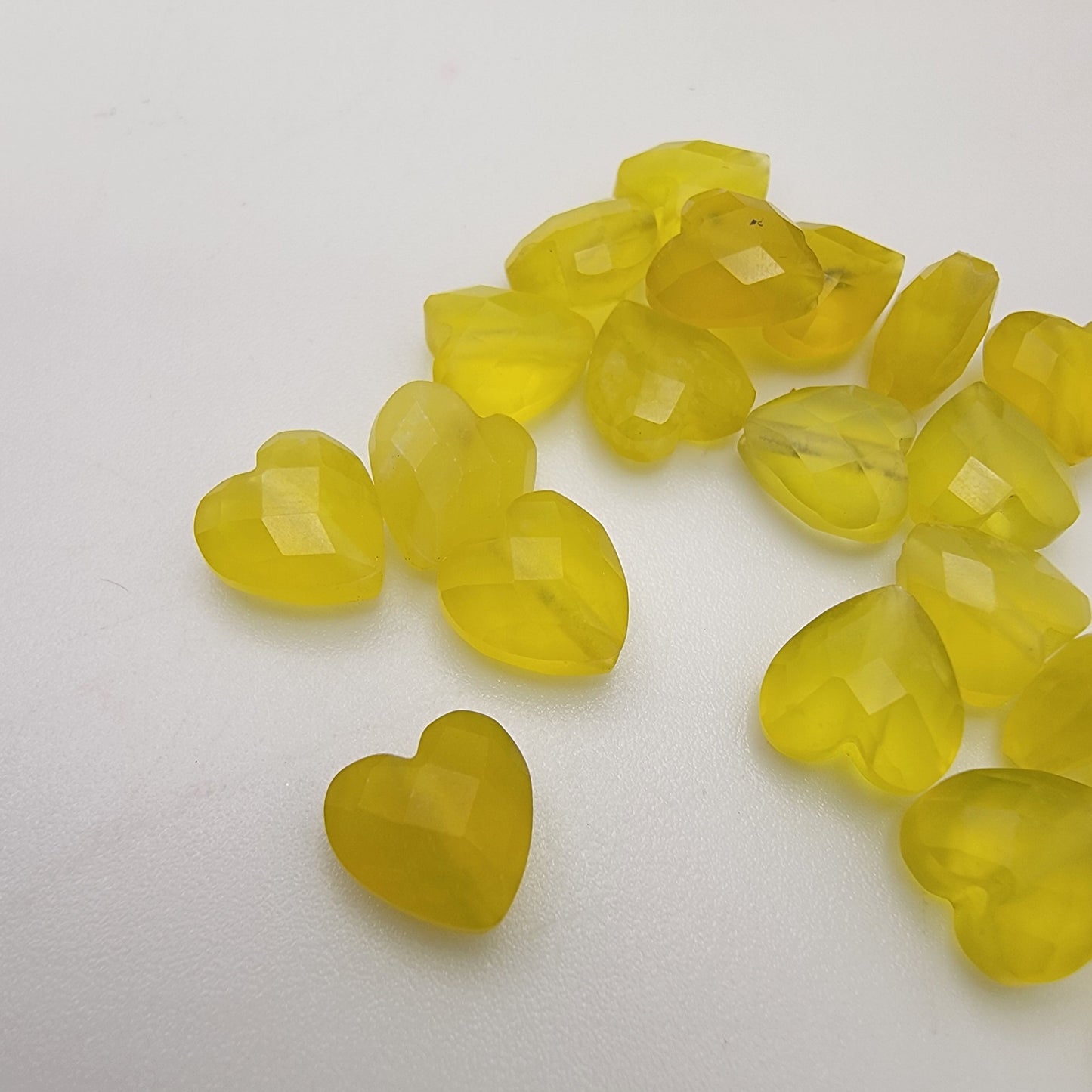 Green heart-shaped beads on a white background