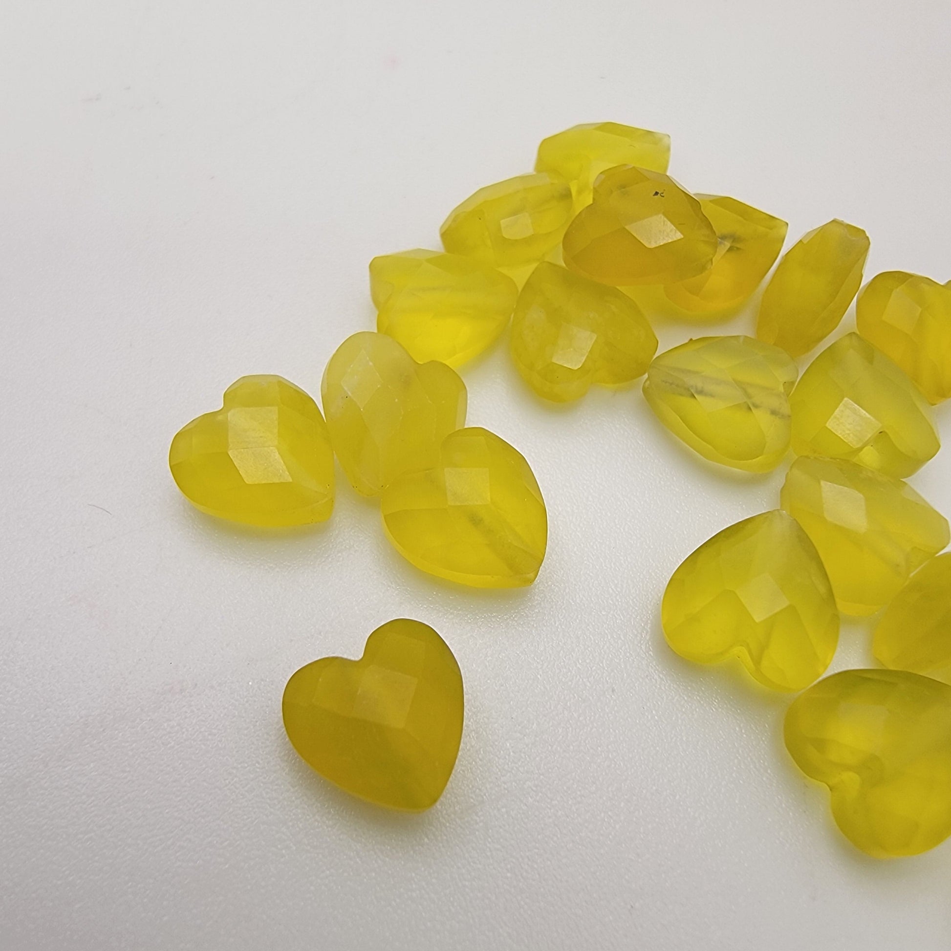 Green heart-shaped beads on a white background
