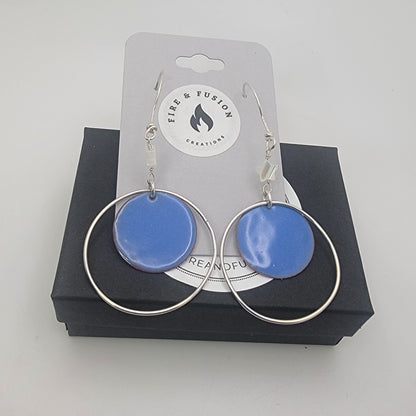 Blue circular earrings with silver loops on a 'Fire & Fusion Creations' card.