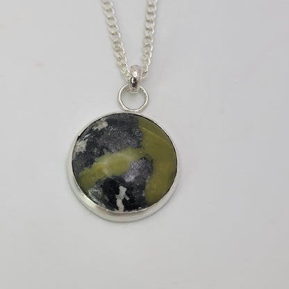 Green and gray gemstone pendant set in sterling silver on silver curb chain