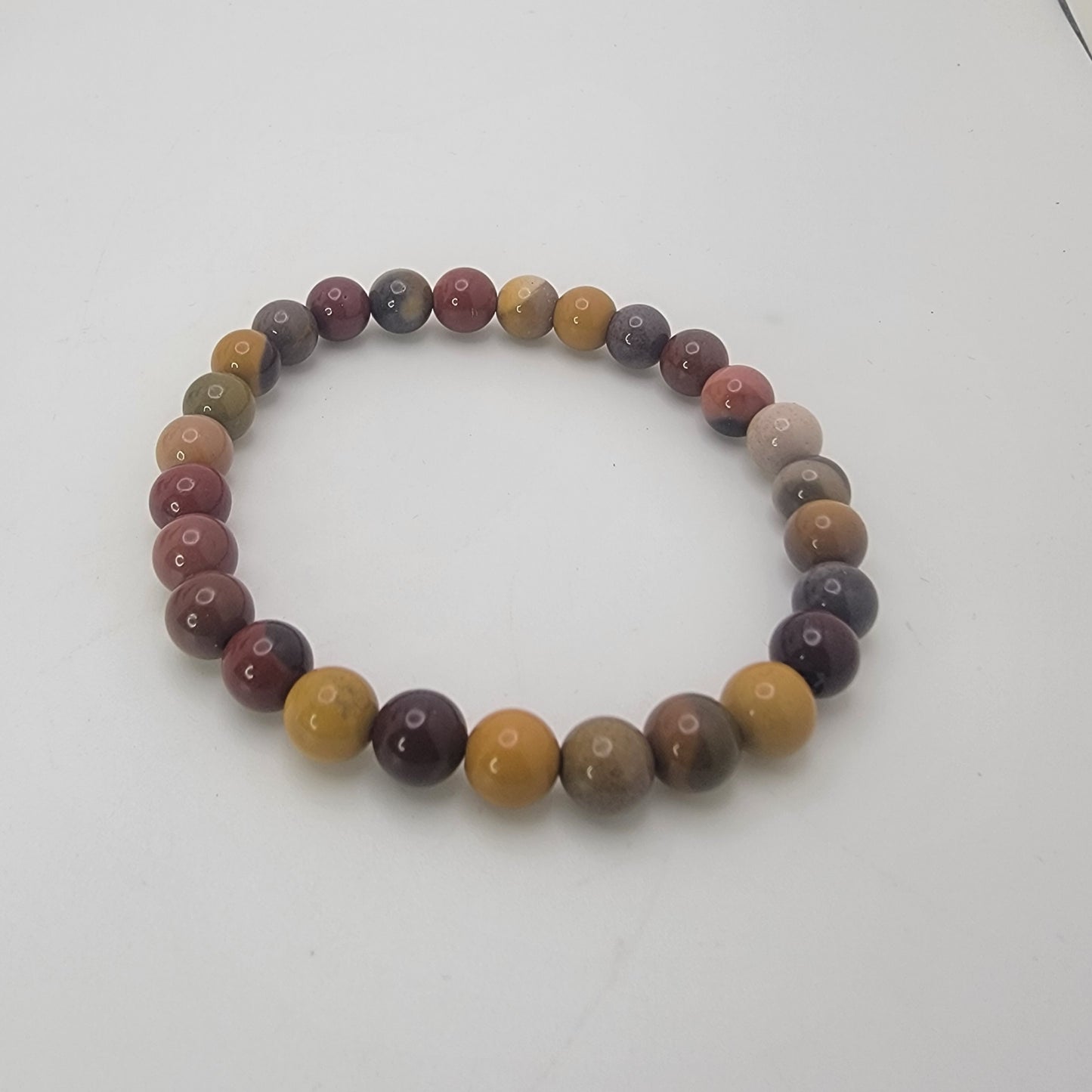 Earth tone beaded bracelet on a white background